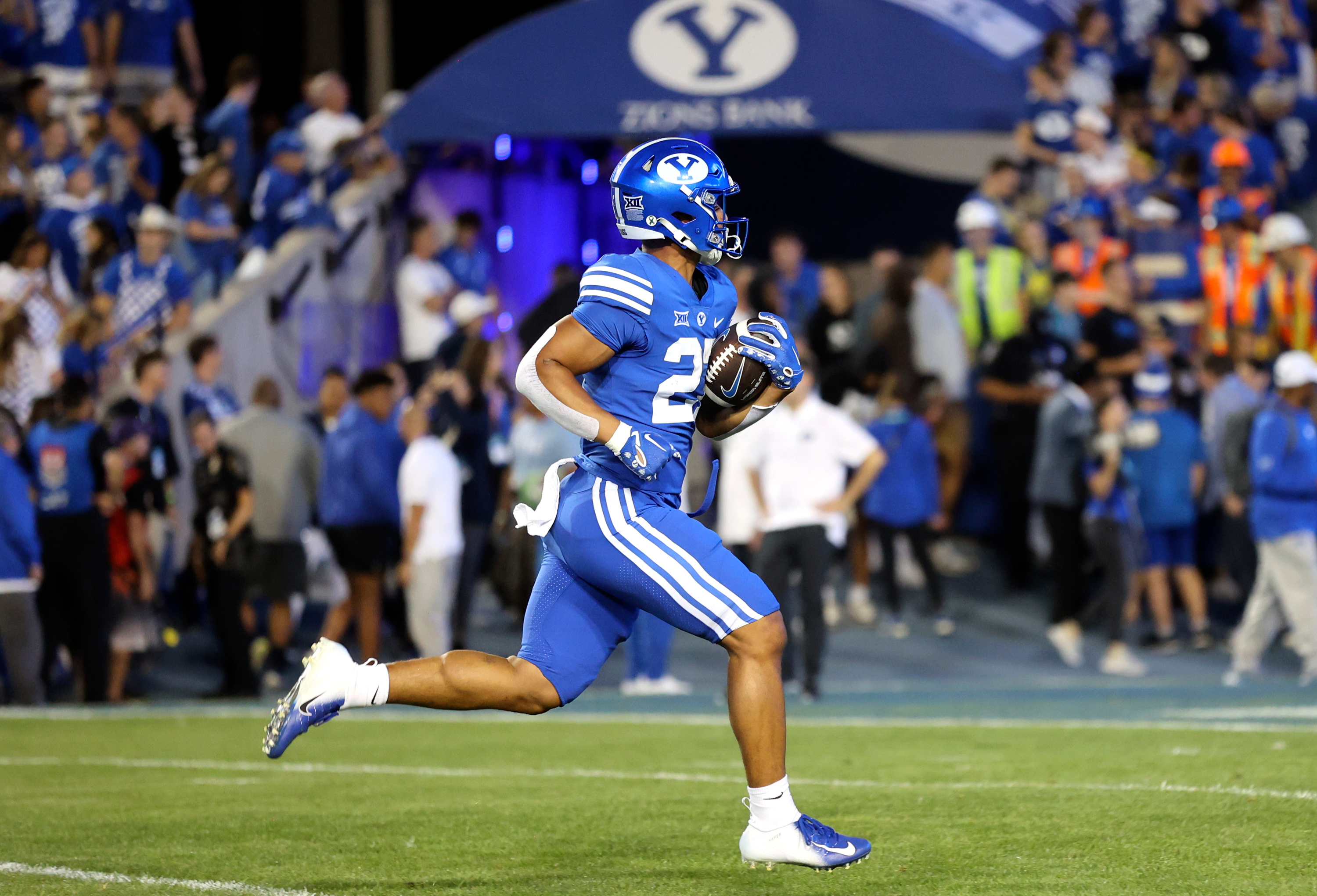 Players warm up before the Brigham Young Cougars play the Cincinnati Bearcats at LaVell Edwards Stadium in Provo on Friday, Sept. 29, 2023.