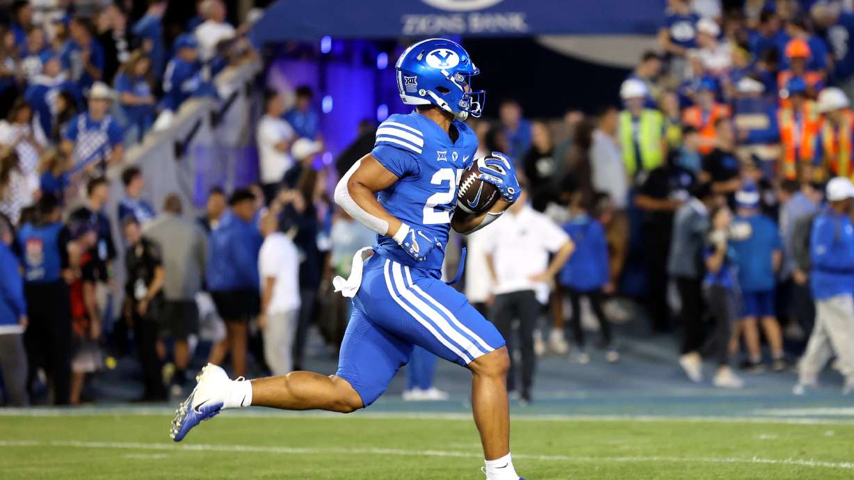 Players warm up before the Brigham Young Cougars play the Cincinnati Bearcats at LaVell Edwards Stadium in Provo on Friday, Sept. 29, 2023.