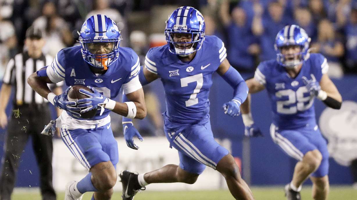 Brigham Young Cougars cornerback Jakob Robinson (0) intercepts a pass intended for the Cincinnati Bearcats and runs for a touchdown during the first half of a football game at LaVell Edwards Stadium in Provo on Friday, Sept. 29, 2023.