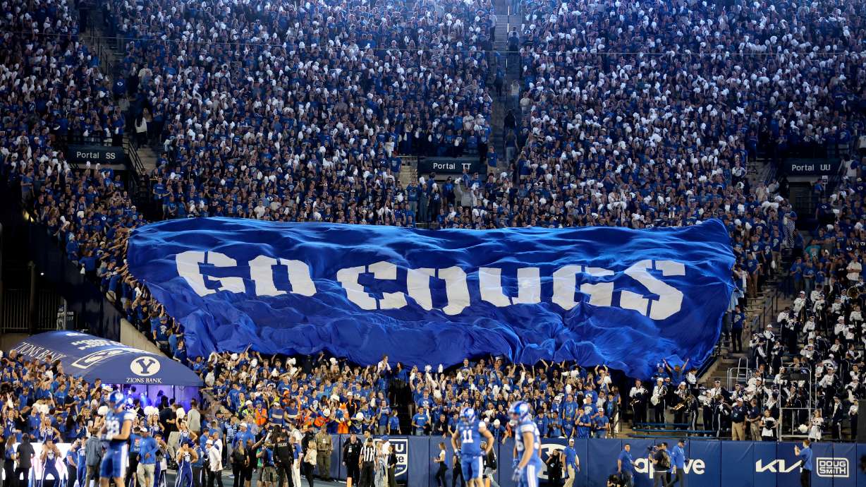 Fans cheer as the Brigham Young Cougars play the Cincinnati Bearcats in a football game at LaVell Edwards Stadium in Provo on Friday, Sept. 29, 2023.