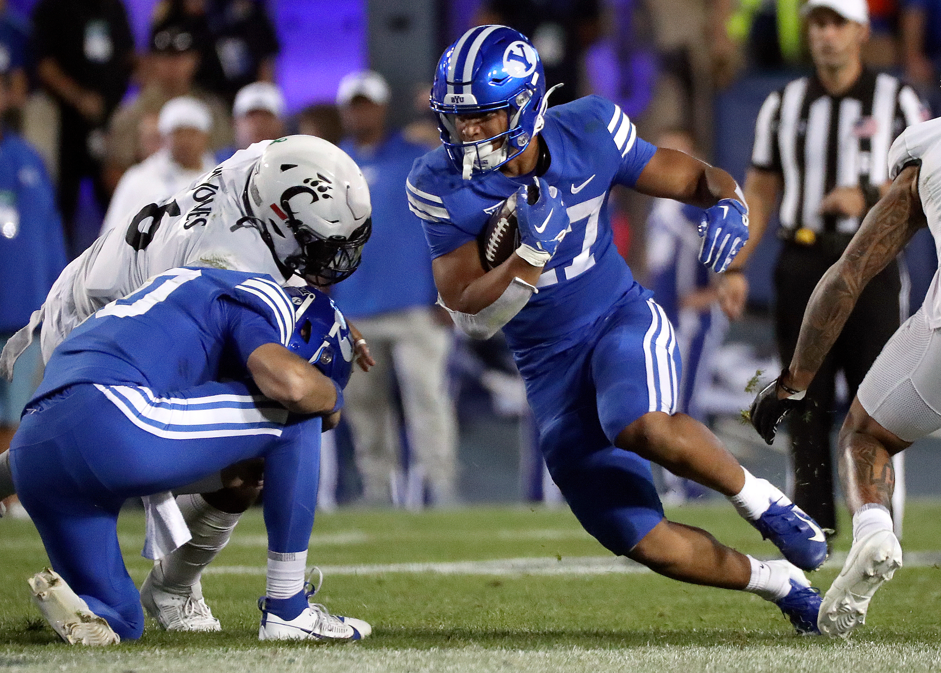 Brigham Young running back LJ Martin (27) runs with the ball as the Cougars play the Cincinnati Bearcats in the second half of a football game at LaVell Edwards Stadium in Provo on Friday, Sept. 29, 2023. BYU won 35-27.