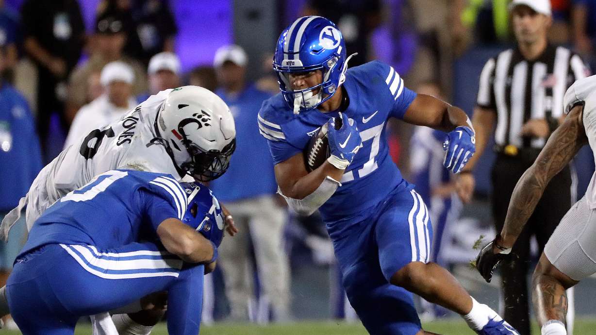 Brigham Young running back LJ Martin (27) runs with the ball as the Cougars play the Cincinnati Bearcats in the second half of a football game at LaVell Edwards Stadium in Provo on Friday, Sept. 29, 2023. BYU won 35-27.