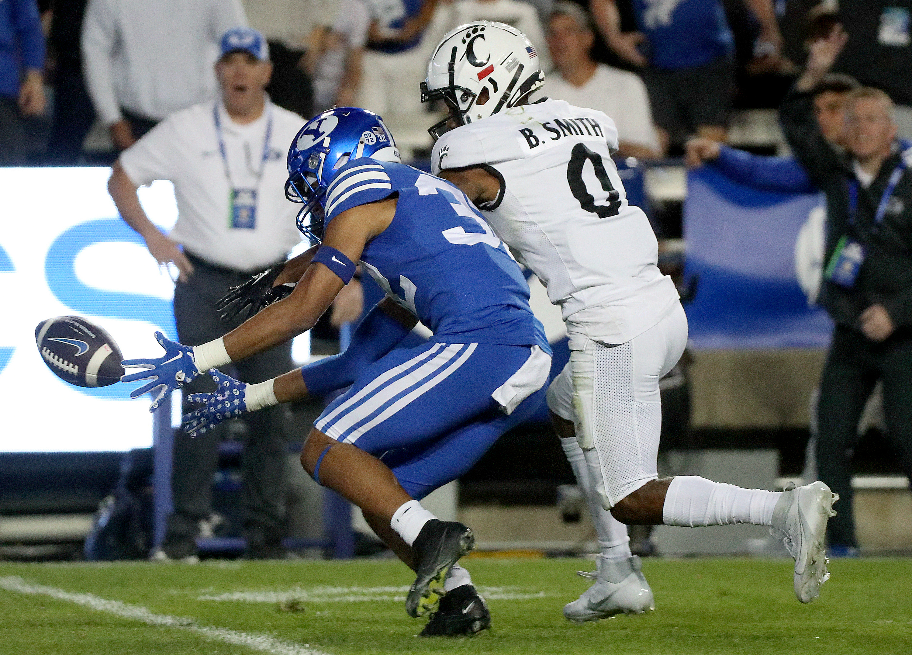 Brigham Young cornerback Marcus McKenzie (32) tries to recover a muffed punt by Cincinnati wide receiver Braden Smith (0) during the second half of a football game at LaVell Edwards Stadium in Provo on Friday, Sept. 29, 2023. BYU won 35-27.