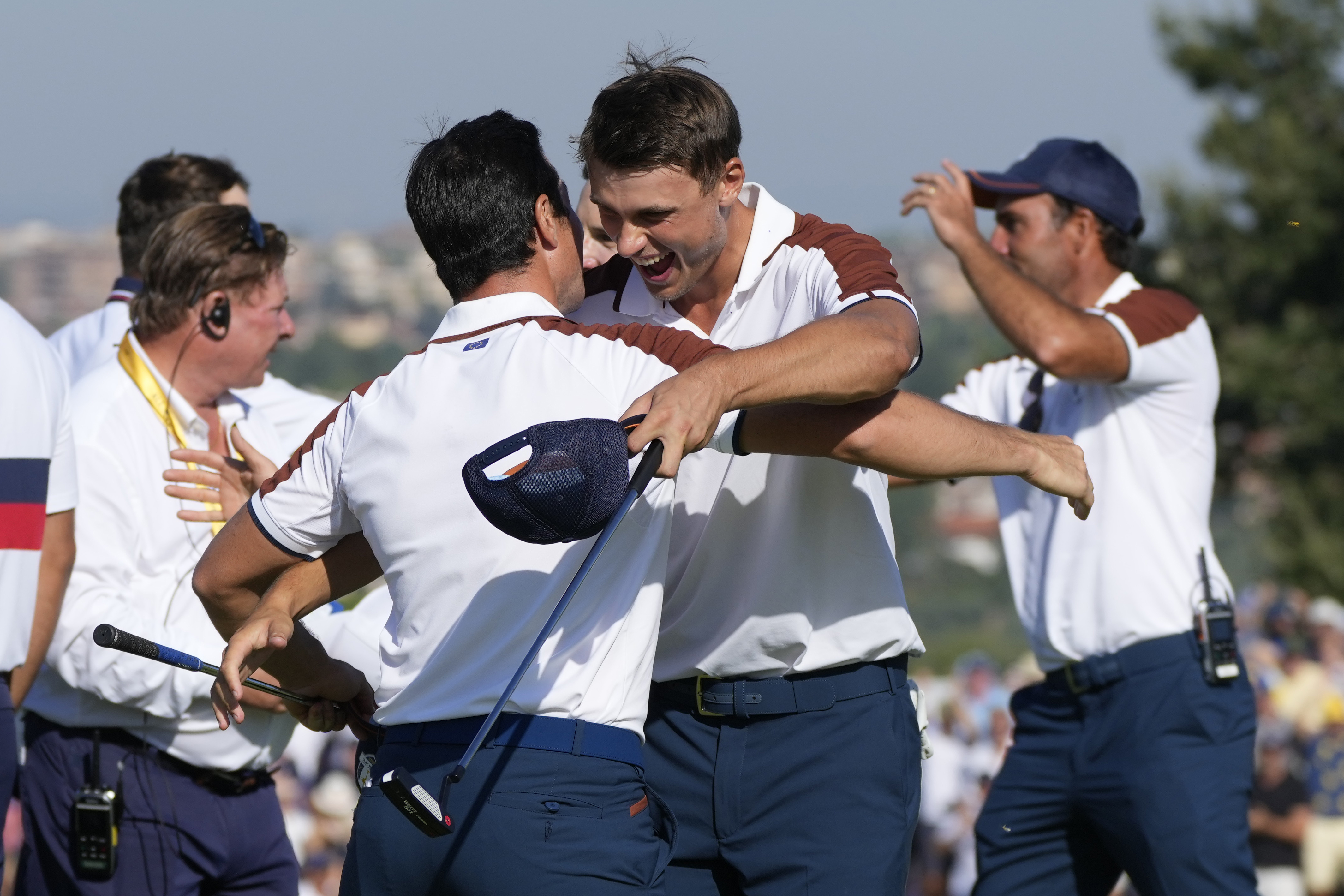 Europe's Viktor Hovland, left and Europe's Ludvig Aberg hug on the 11th green after defeating the United States pair of Scottie Scheffler and Brooks Koepka 9&7, during their morning Foursomes match at the Ryder Cup golf tournament at the Marco Simone Golf Club in Guidonia Montecelio, Italy, Saturday, Sept. 30, 2023.