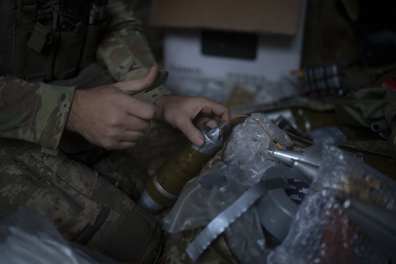 A Ukrainian soldier prepares a bomb to attach to an exploding drone on the outskirts of Kremmina, Ukraine, Aug. 20. The drone unit's task is to destroy Russia's heavy machinery, armored vehicles and infantry. The drone unit's task is to destroy Russia's heavy machinery, armored vehicles and infantry.