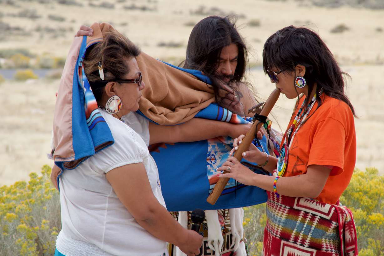 Thalia/Star Guerrero plays the flute as an offering of peace to the Great Salt Lake during an offering ceremony on Antelope Island on Saturday. Guerrero and her grandmother, Paiute Indian Tribe of Utah Chairwoman Corrina Bow (left), are members of the Kanosh Band, or Pahvants, meaning "water is there."