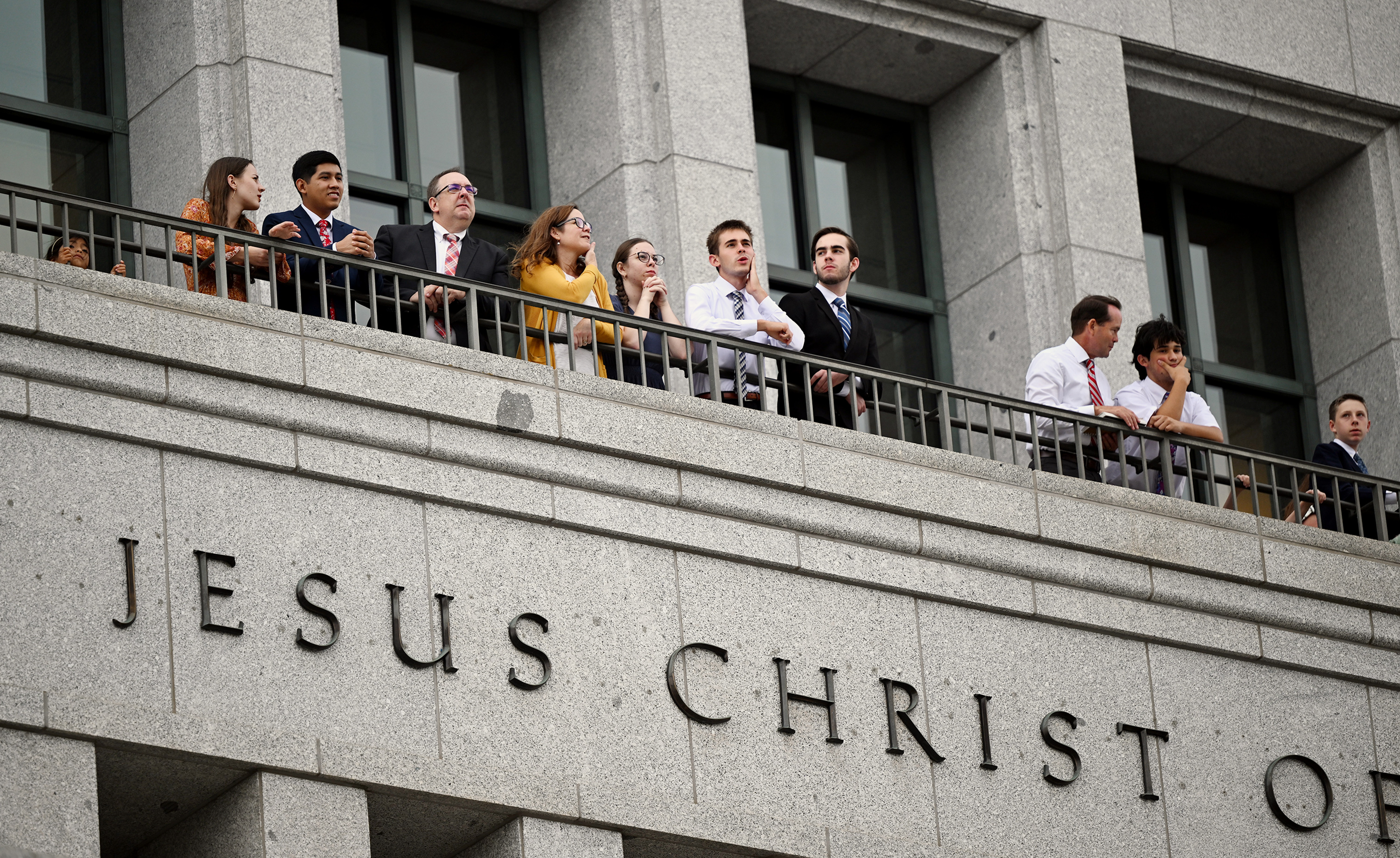 People stand and look out at the Salt Lake Temple Saturday from the Conference Center of The Church of Jesus Christ of Latter-day Saints in Salt Lake City. The church's general conference is underway this weekend.