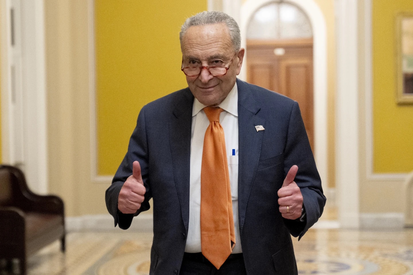 Senate Majority Leader Chuck Schumer, D-N.Y., gives two thumbs up as the Senate votes to approve a 45-day funding bill to keep federal agencies open, Saturday in Washington.