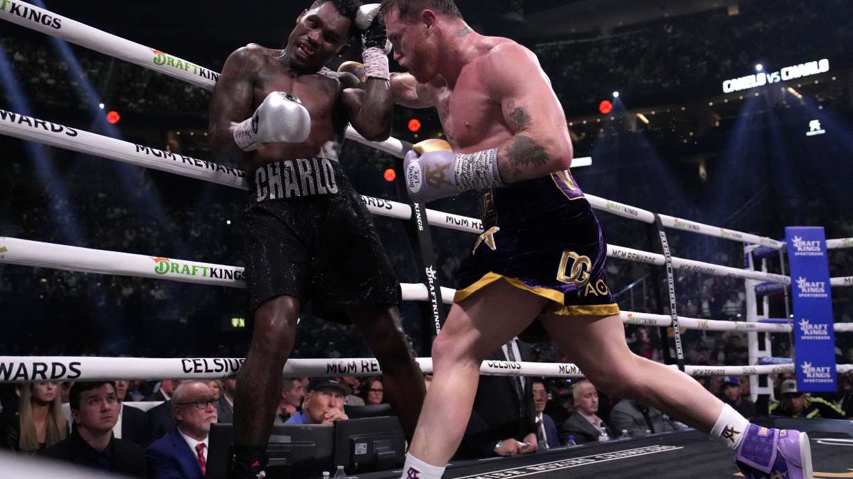 Canelo Alvarez, of Mexico, right, fights Jermell Charlo in a super middleweight title boxing match, Saturday, Sept. 30, 2023, in Las Vegas.
