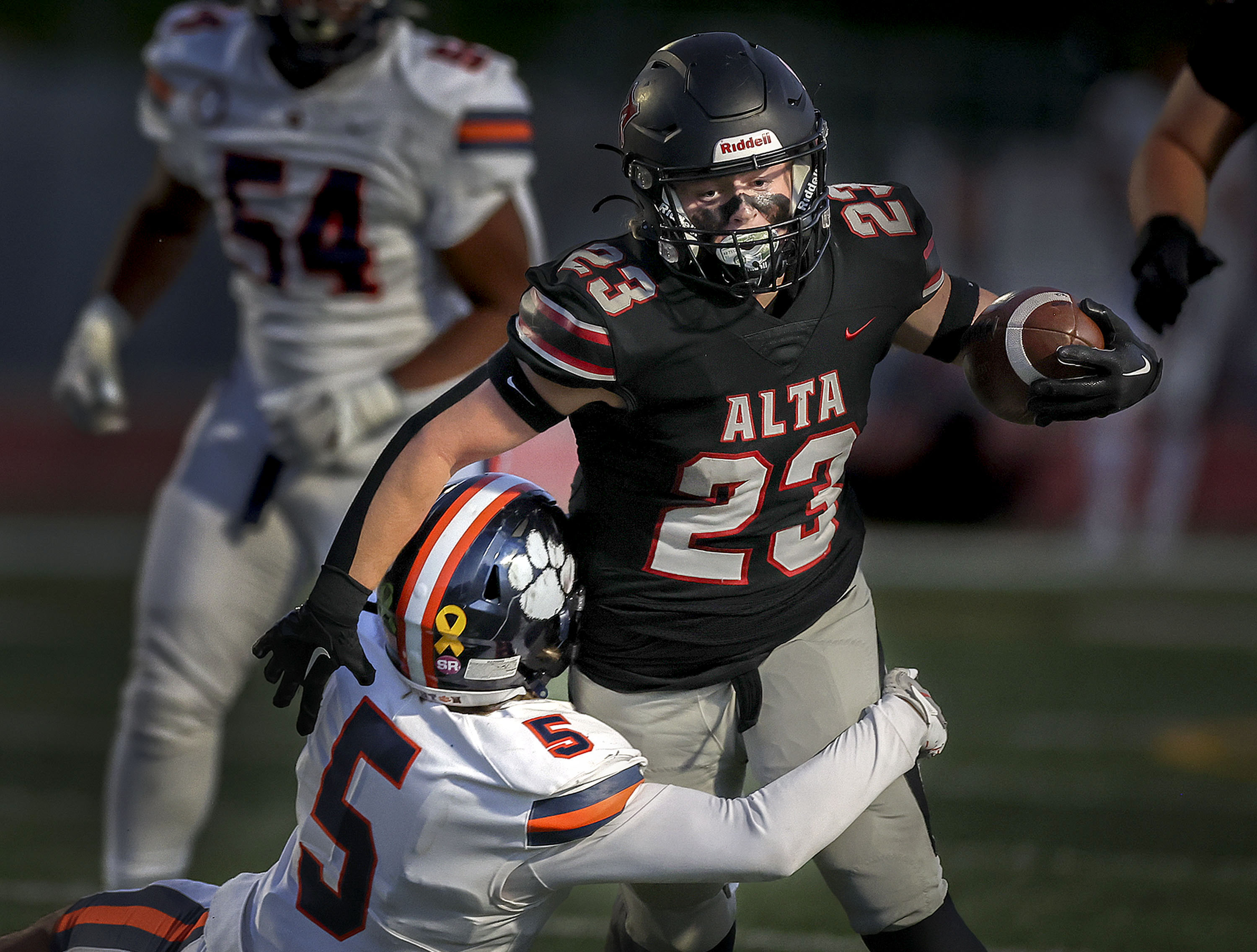 Alta’s Nolan Lohnes drives past Brighton’s Miles Morgan as Brighton High School and Alta High School compete in a Week 8 football showdown at Alta High in Sandy on Friday, Sept. 29, 2023.