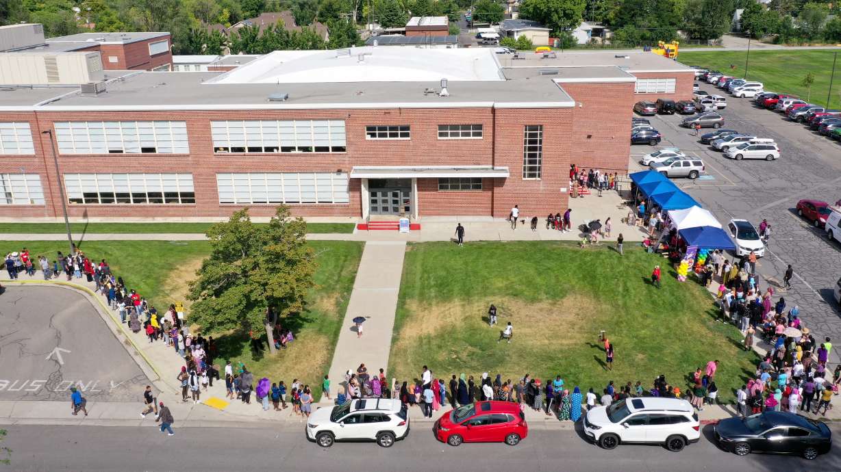 People line up for Refugee Back to School Night at Granite Park Junior High in South Salt Lake on Aug. 7. A former staffer has admitted to sexually abusing a student, as well as other crimes against additional students.