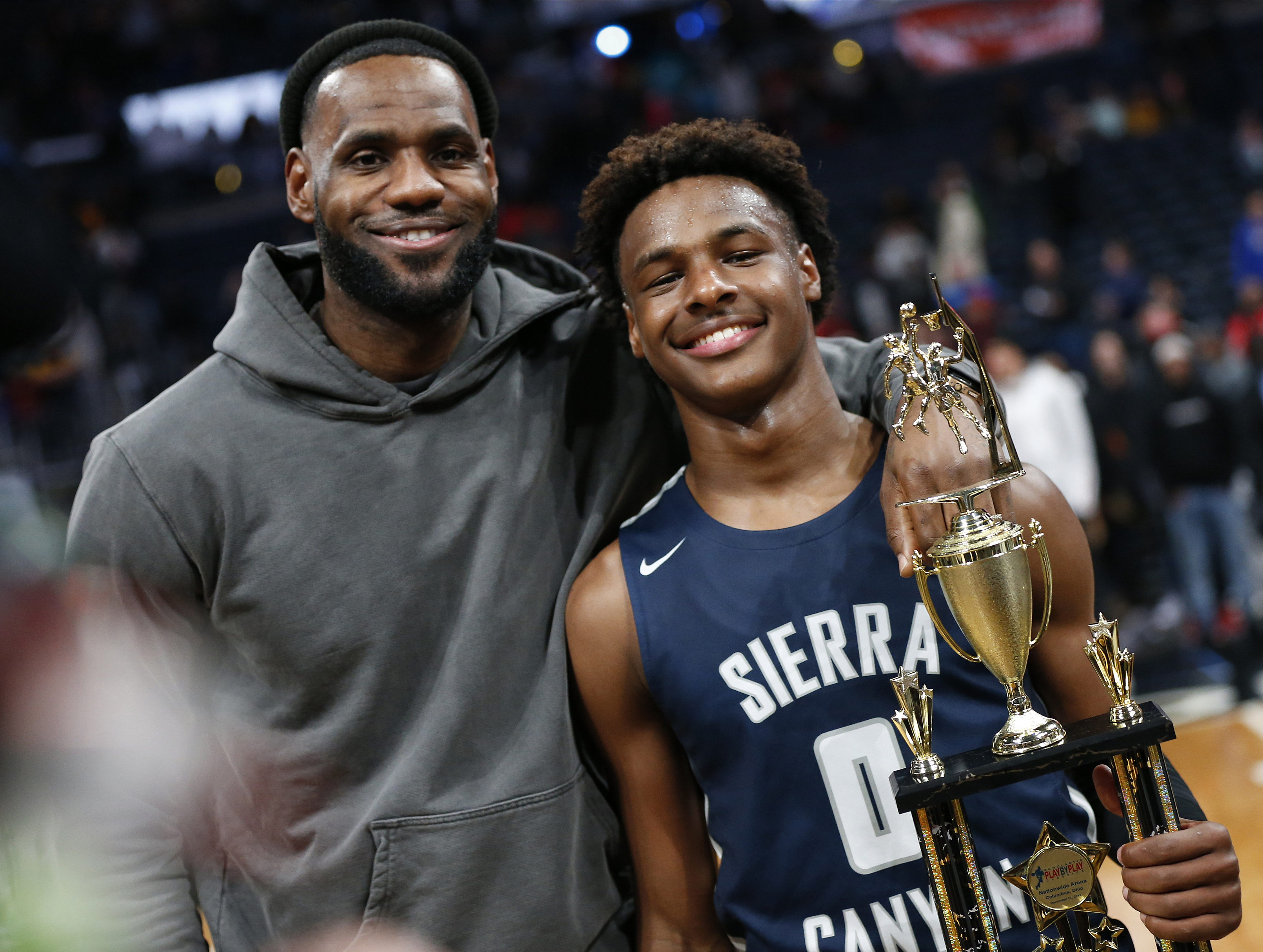 FILE - LeBron James, left, poses with his son Bronny after Sierra Canyon beat Akron St. Vincent - St. Mary in a high school basketball game, Saturday, Dec. 14, 2019, in Columbus, Ohio. LeBron James says his son, Bronny, is progressing in his rehabilitation from cardiac arrest in hopes of playing for the University of Southern California this season. James gave the update on his 18-year-old son Monday, Oct. 2, 2023, when the Los Angeles Lakers held their annual media day ahead of training camp.