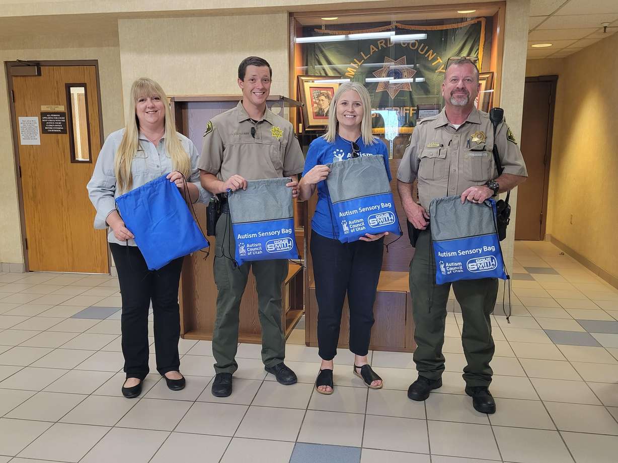 Michelle Hiles, center right, stands with employees at the Millard County Sheriff’s Office after they received autism sensory bags for deputies.