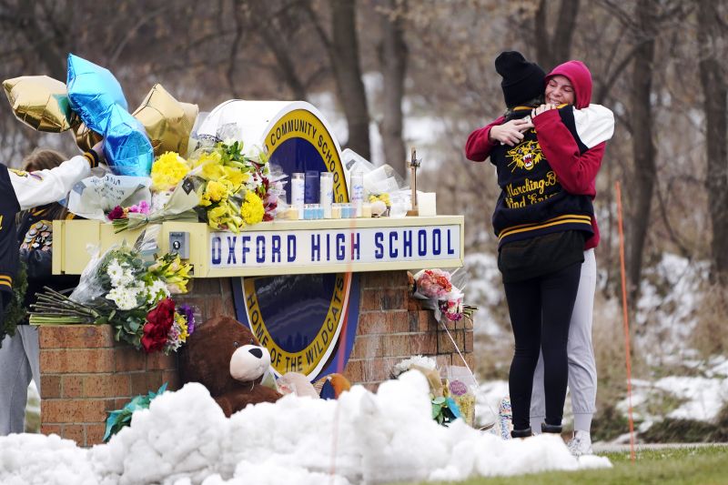 Students hug at a memorial at Oxford High School in Oxford, Mich., Dec. 1, 2021. The Michigan Supreme Court turned down an appeal Tuesday, clearing the way for the parents of the Oxford High School shooter to face trial on involuntary manslaughter charges.