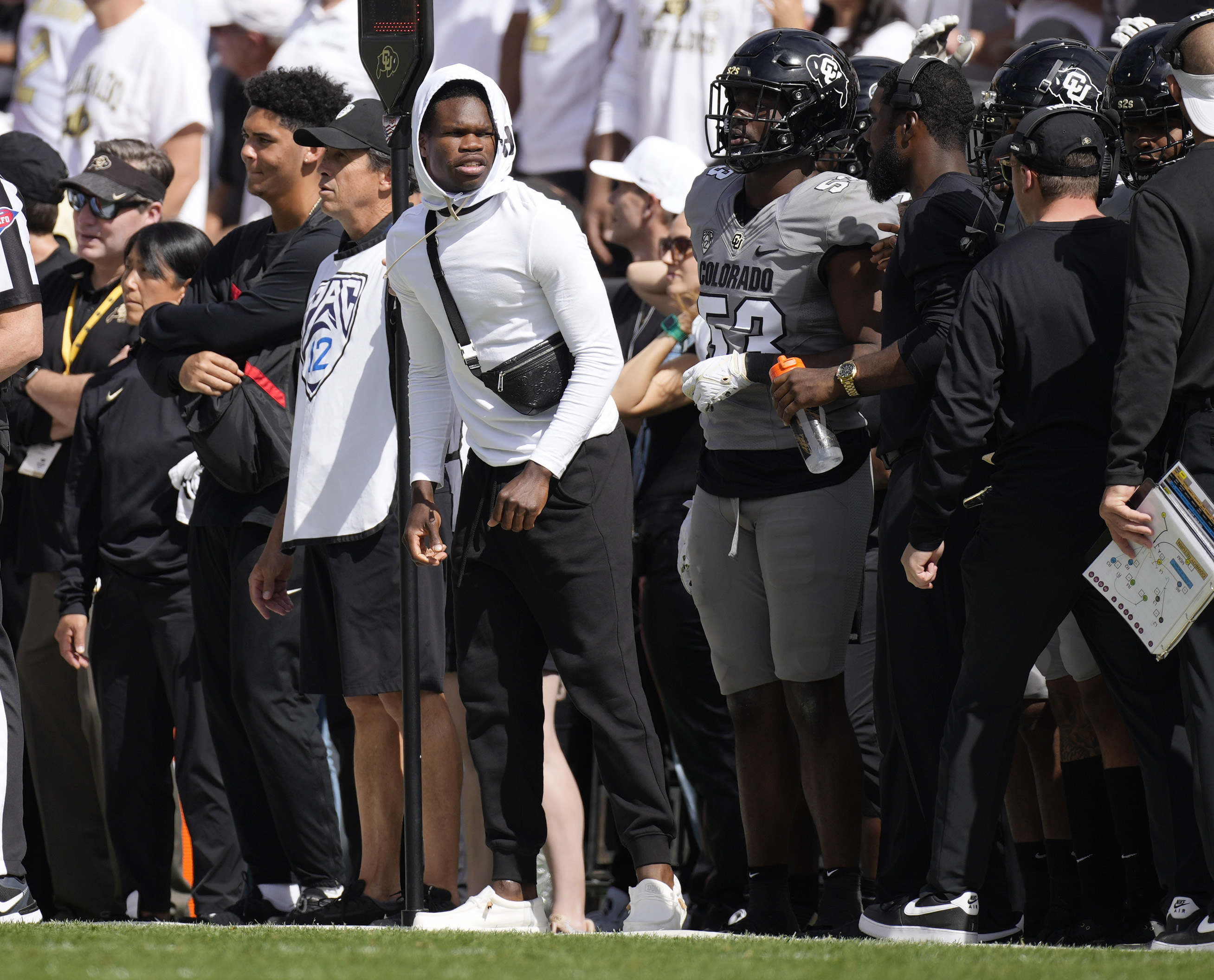 Injured Colorado defensive back Travis Hunter, center, looks on from the sideline in the second half of an NCAA college football game against Southern California, Saturday, Sept. 30, 2023, in Boulder, Colo.