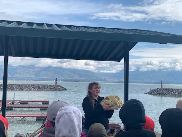 Leah Stutz shows a replica skull of a saber tooth cat, which used to inhabit the Utah Lake area during the ice age. The activity was part of a fourth grade field trip to Utah Lake in Saratoga Springs on Tuesday.