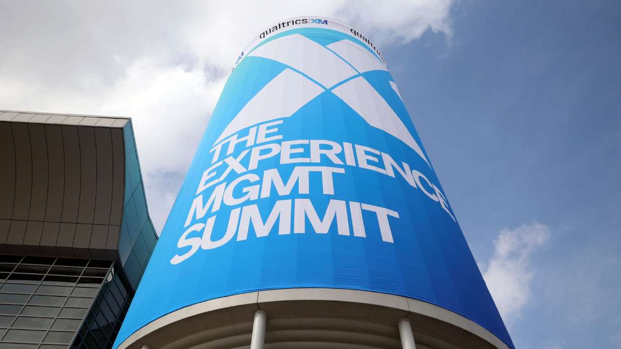 Signage is pictured for Qualtrics X4: The Experience Management Summit at the Salt Palace Convention Center in Salt Lake City, March 7. The tech company announced Wednesday it is cutting its workforce by 15% amid restructuring.