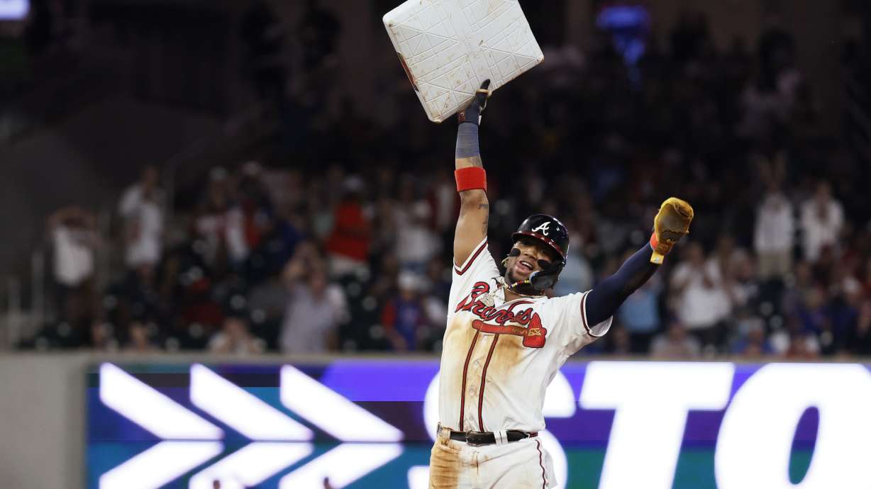 Atlanta Braves' Ronald Acuña Jr. (13) holds up the base after stealing second against the Chicago Cubs during the 10th inning of a baseball game Wednesday, Sept. 27, 2023, in Atlanta. It was Acuña's 70th stolen base of the season.