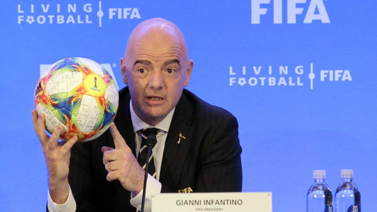 FILE - FIFA President Gianni Infantino holds a soccer ball as he speaks during a press conference after the FIFA Council Meeting, Friday, March 15, 2019, in Miami. FIFA is moving more than 100 jobs from its Swiss headquarters to Florida where a growing workforce is already working on organizing the 2026 World Cup. FIFA informed staff Tuesday, Sept. 26, 2023 the entire legal department plus audit, compliance and risk management teams will move from Zurich to Coral Gables near Miami.