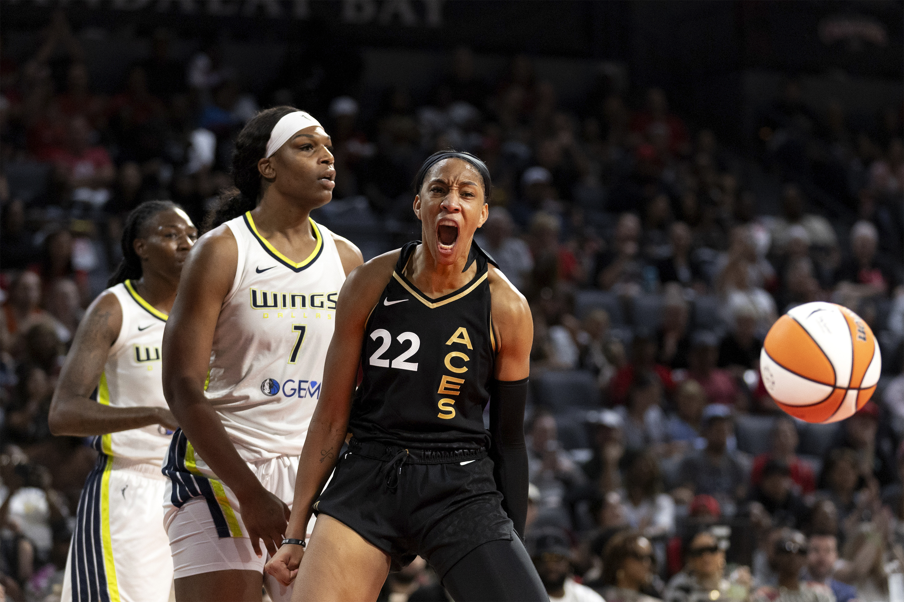 Las Vegas Aces forward A'ja Wilson (22) celebrates after Dallas Wings center Teaira McCowan (7) was charged with a foul during the second half Game 1 of a WNBA basketball semifinal series Sunday, Sept. 24, 2023, in Las Vegas.