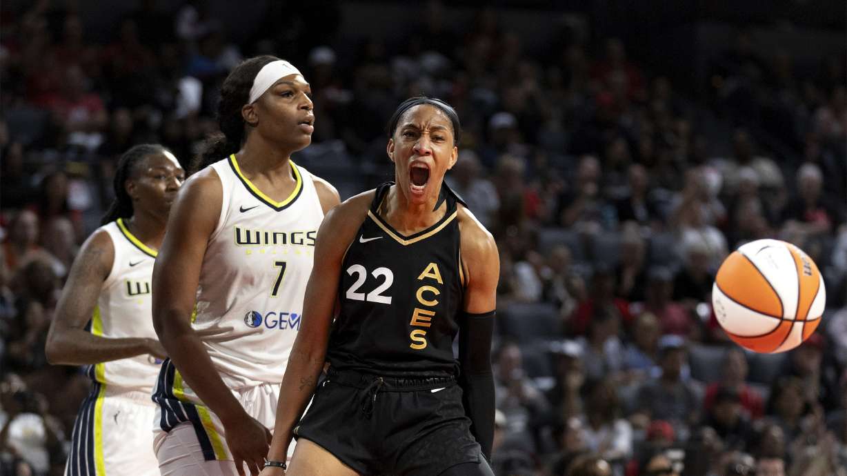 Las Vegas Aces forward A'ja Wilson (22) celebrates after Dallas Wings center Teaira McCowan (7) was charged with a foul during the second half Game 1 of a WNBA basketball semifinal series Sunday, Sept. 24, 2023, in Las Vegas.