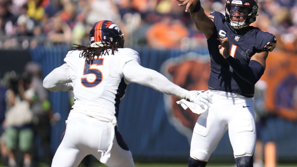 Chicago Bears quarterback Justin Fields passes under pressure from Denver Broncos linebacker Randy Gregory during the first half of an NFL football game Sunday, Oct. 1, 2023, in Chicago.