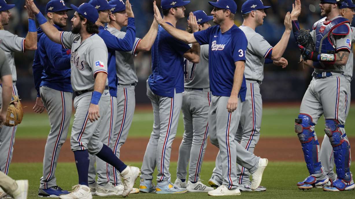Texas Rangers players celebrate after beating the Tampa Bay Rays 7-1 during Game 2 in an AL wild-card baseball playoff series, Wednesday, Oct. 4, 2023, in St. Petersburg, Fla.