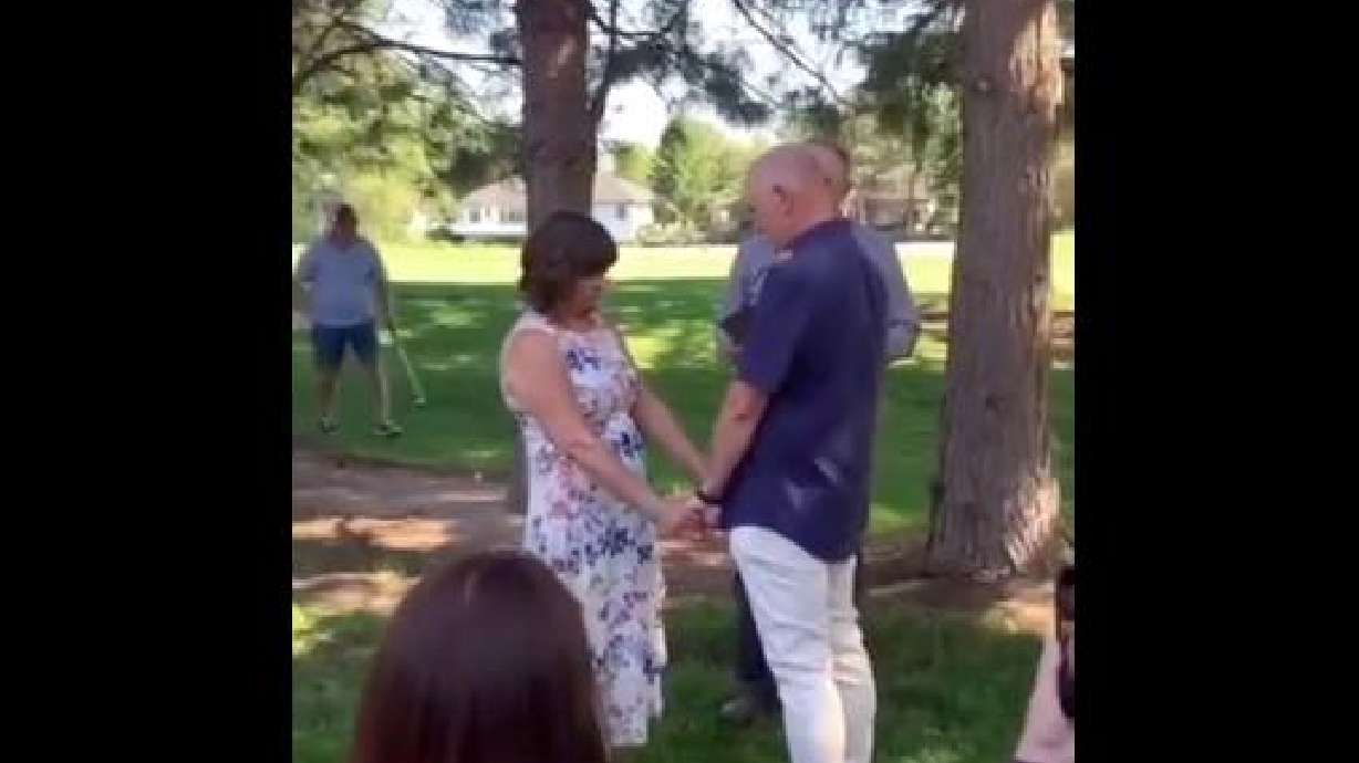 A golfer spares no feelings, taking a shot in the middle of a wedding on the golf course.