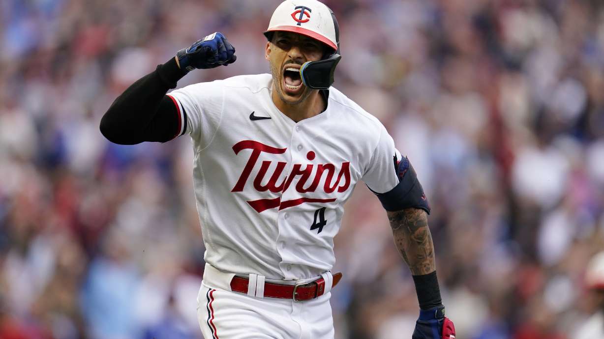 Minnesota Twins' Carlos Correa reacts after hitting an RBI single during the fourth inning of Game 2 of an AL wild-card baseball playoff series against the Toronto Blue Jays Wednesday, Oct. 4, 2023, in Minneapolis.