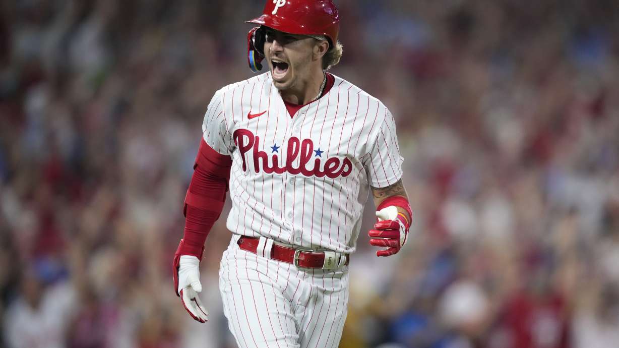Philadelphia Phillies' Bryson Stott reacts after hitting a grand slam against Miami Marlins pitcher Andrew Nardi during the sixth inning of Game 2 in an NL wild-card baseball playoff series, Wednesday, Oct. 4, 2023, in Philadelphia.