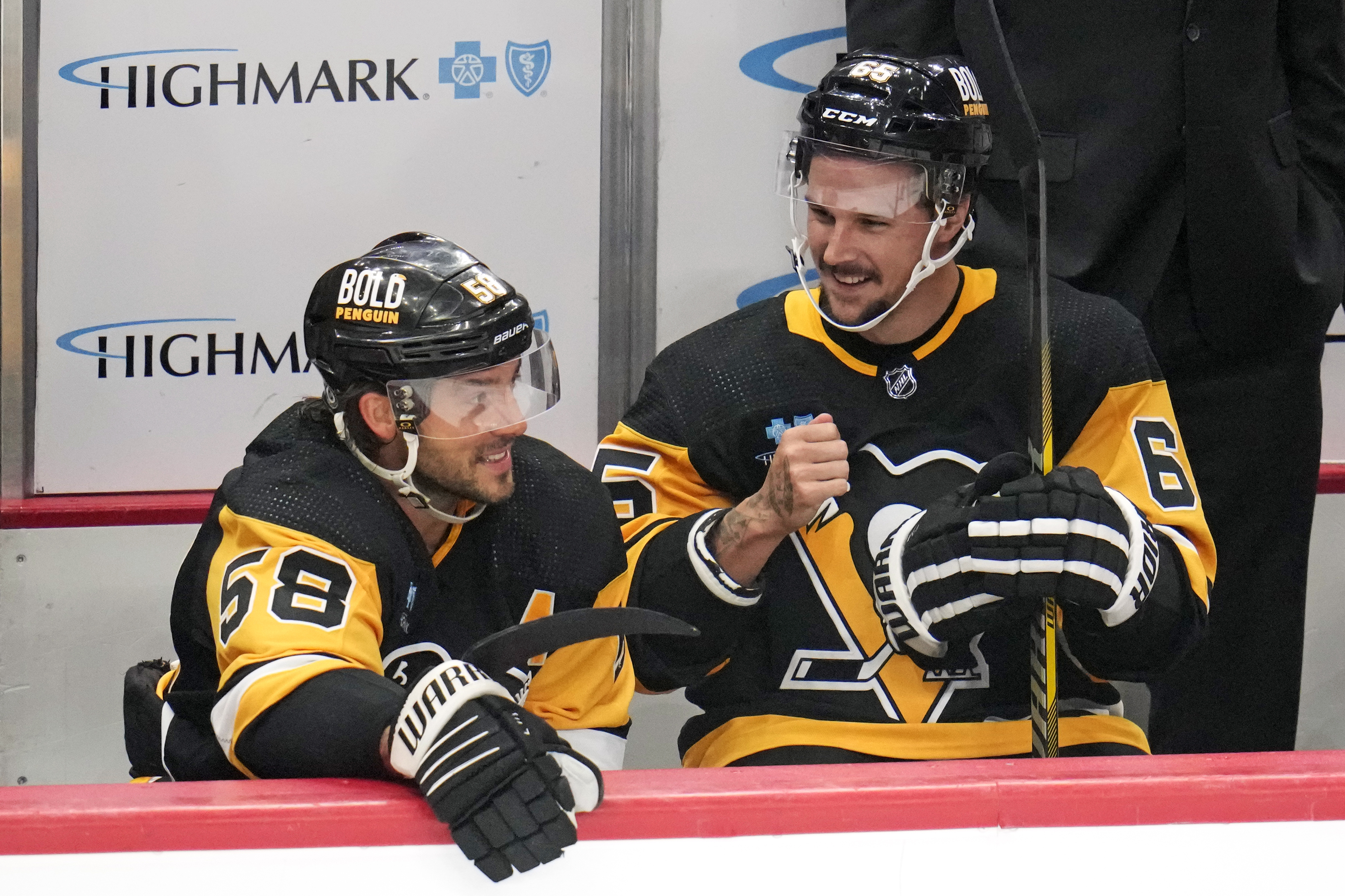 Pittsburgh Penguins' Kris Letang, left, and Erik Karlsson sit on the bench during the first period of an NHL hockey preseason game against the Buffalo Sabres in Pittsburgh, Thursday, Sept. 28, 2023.