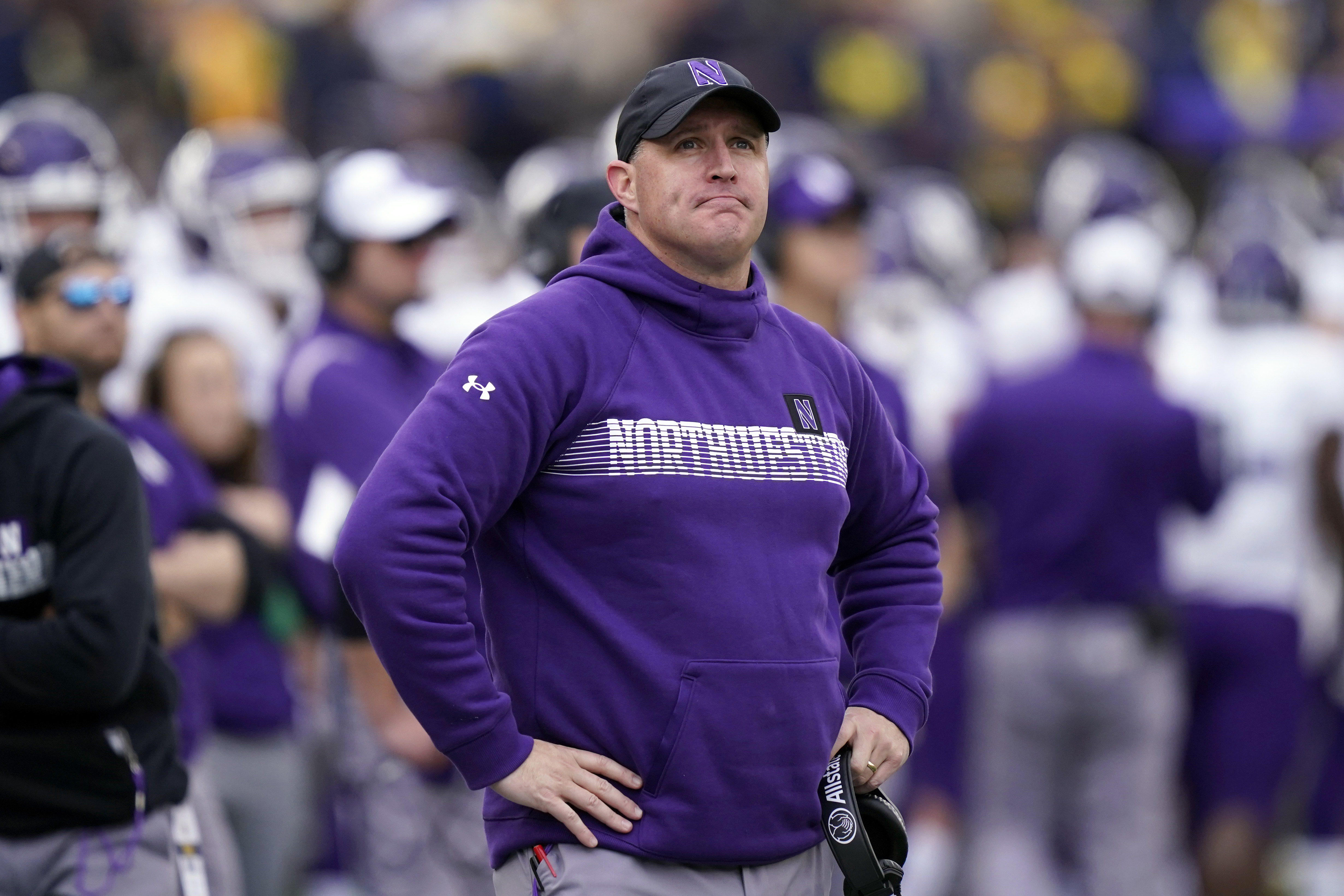 FILE - Northwestern head coach Pat Fitzgerald stands on the sideline during the first half of an NCAA college football game against Michigan, Oct. 23, 2021, in Ann Arbor, Mich. Former Northwestern University football coach Pat Fitzgerald is suing the school for $130 million, saying his alma mater wrongfully fired him in the wake of a hazing and abuse scandal that has engulfed the athletic department. The announcement by Chicago-based attorneys Dan K. Webb and Matthew R. Carter on Thursday, Oct. 5, 2023, comes nearly three months after Fitzgerald was suspended and then fired after 17 years.