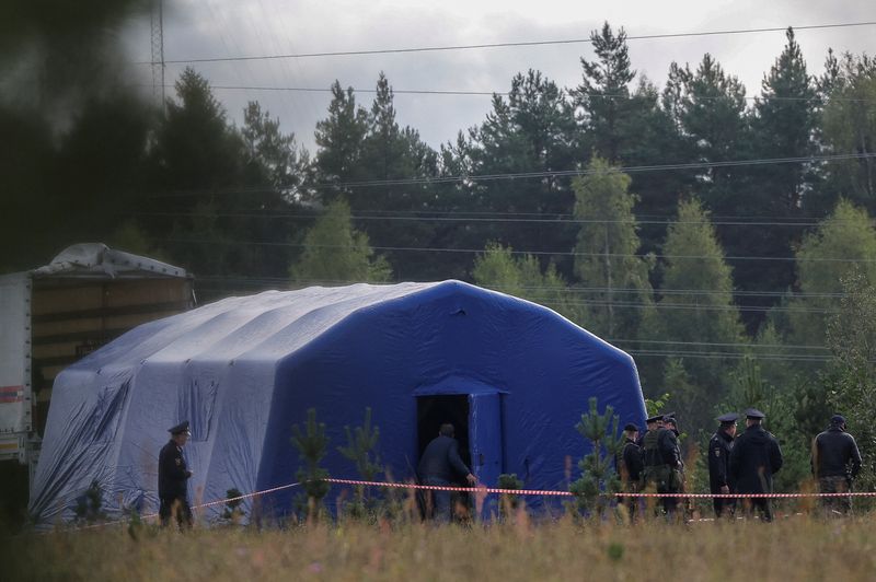Police officers keep guard at a checkpoint near the site of the crash of a private jet linked to Wagner mercenary chief Yevgeny Prigozhin in the Tver region, Russia, on Aug. 24. Russian President Vladimir Putin on Thursday suggested that the plane crash that killed the Wagner mercenary chief in August was caused by hand grenades detonating inside the aircraft, not by a missile attack.