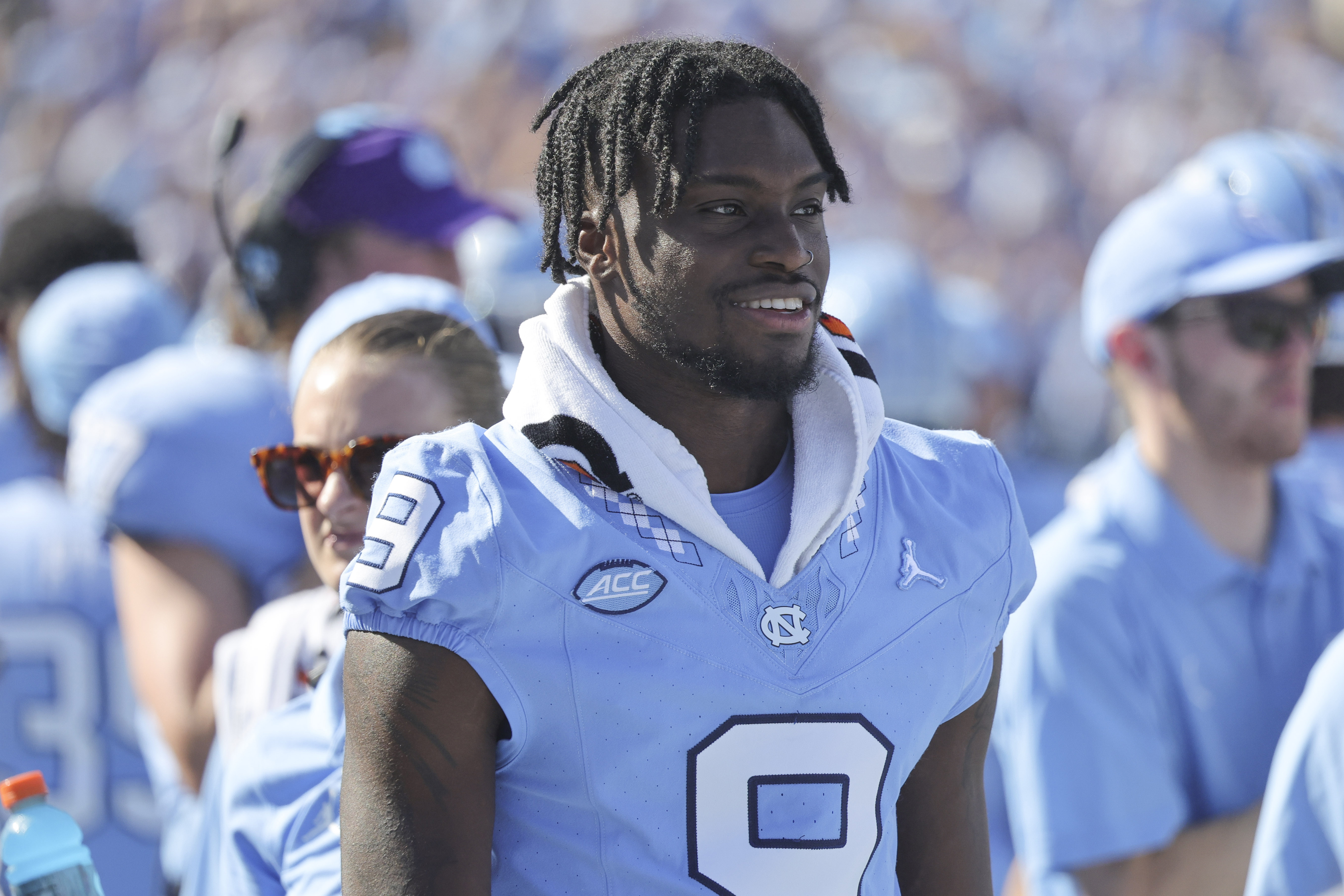 FILE - North Carolina wide receiver Devontez Walker (9) watches the game from the bench during the second quarter of an NCAA college football game against Minnesota, Saturday, Sept. 16, 2023, in Chapel Hill, N.C. The NCAA says wide receiver Tez Walker will be allowed to play for the 14th-ranked North Carolina Tar Heels for the remainder of the season after receiving new information from the school this week. The NCAA released a terse statement Thursday, Oct. 5, saying its staff received new information this week regarding Walker and determined it qualifies Walker for a transfer waiver. 