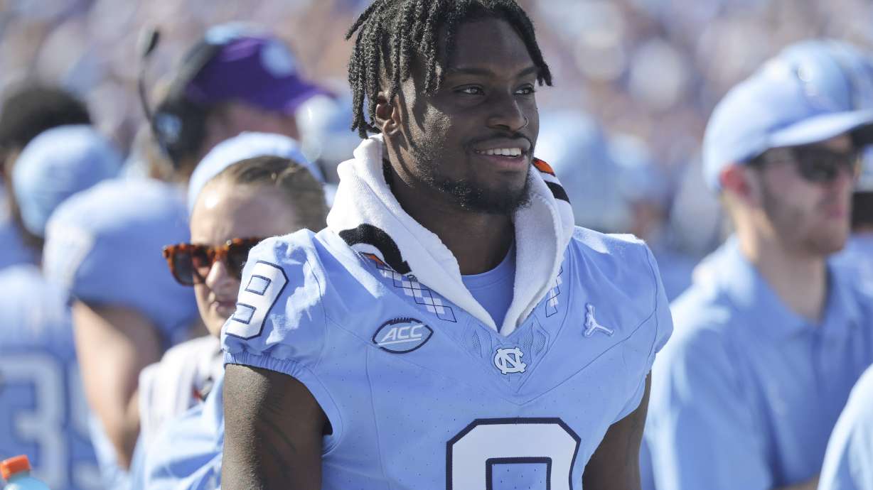 FILE - North Carolina wide receiver Devontez Walker (9) watches the game from the bench during the second quarter of an NCAA college football game against Minnesota, Saturday, Sept. 16, 2023, in Chapel Hill, N.C. The NCAA says wide receiver Tez Walker will be allowed to play for the 14th-ranked North Carolina Tar Heels for the remainder of the season after receiving new information from the school this week. The NCAA released a terse statement Thursday, Oct. 5, saying its staff received new information this week regarding Walker and determined it qualifies Walker for a transfer waiver.