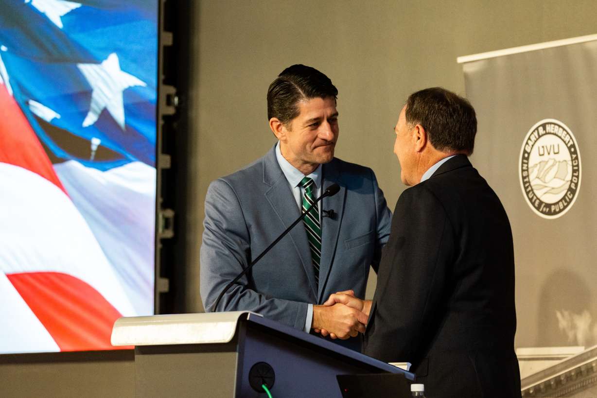 Former House Speaker Paul Ryan shakes hands with former Utah Gov. Gary R. Herbert at Utah Valley University in Orem on Thursday.