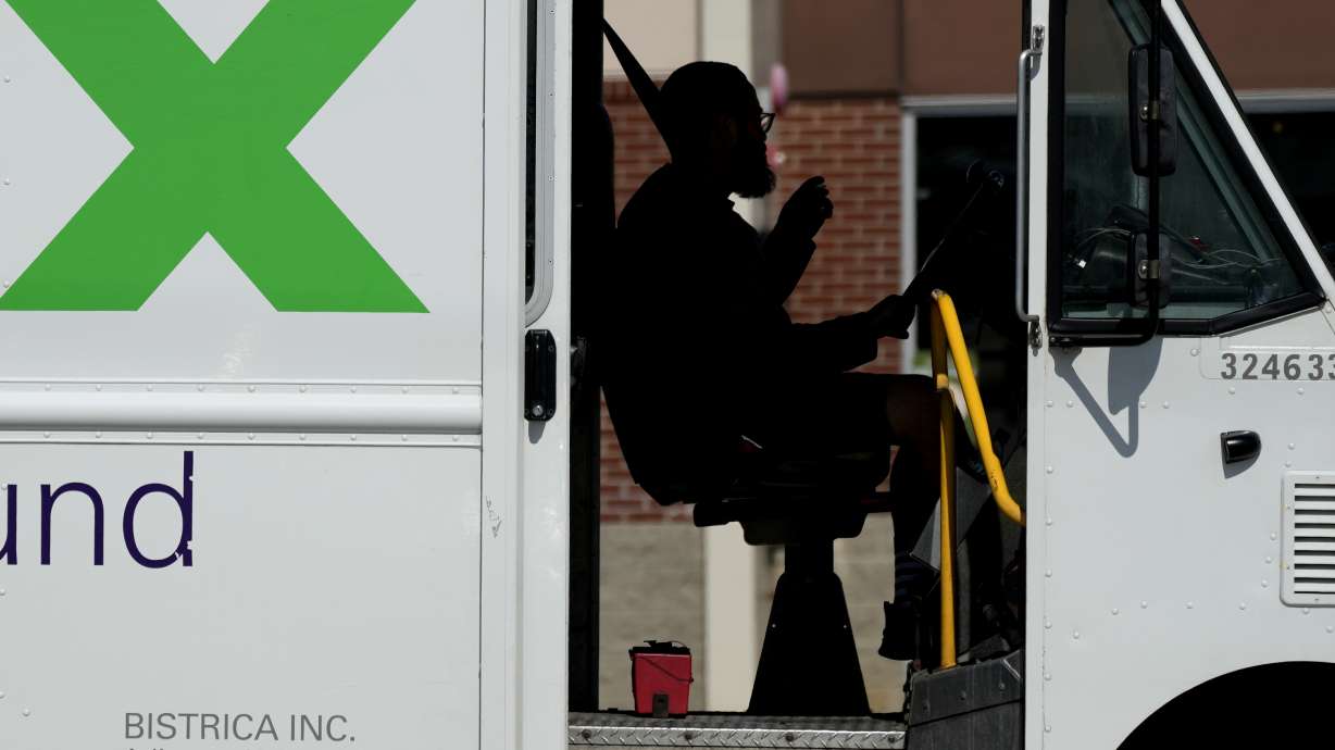 A FedEx driver makes deliveries in Palatine, Ill., Sept. 13. The nation's employers added 336,000 jobs in September, an unexpectedly strong gain, the government reported Friday.
