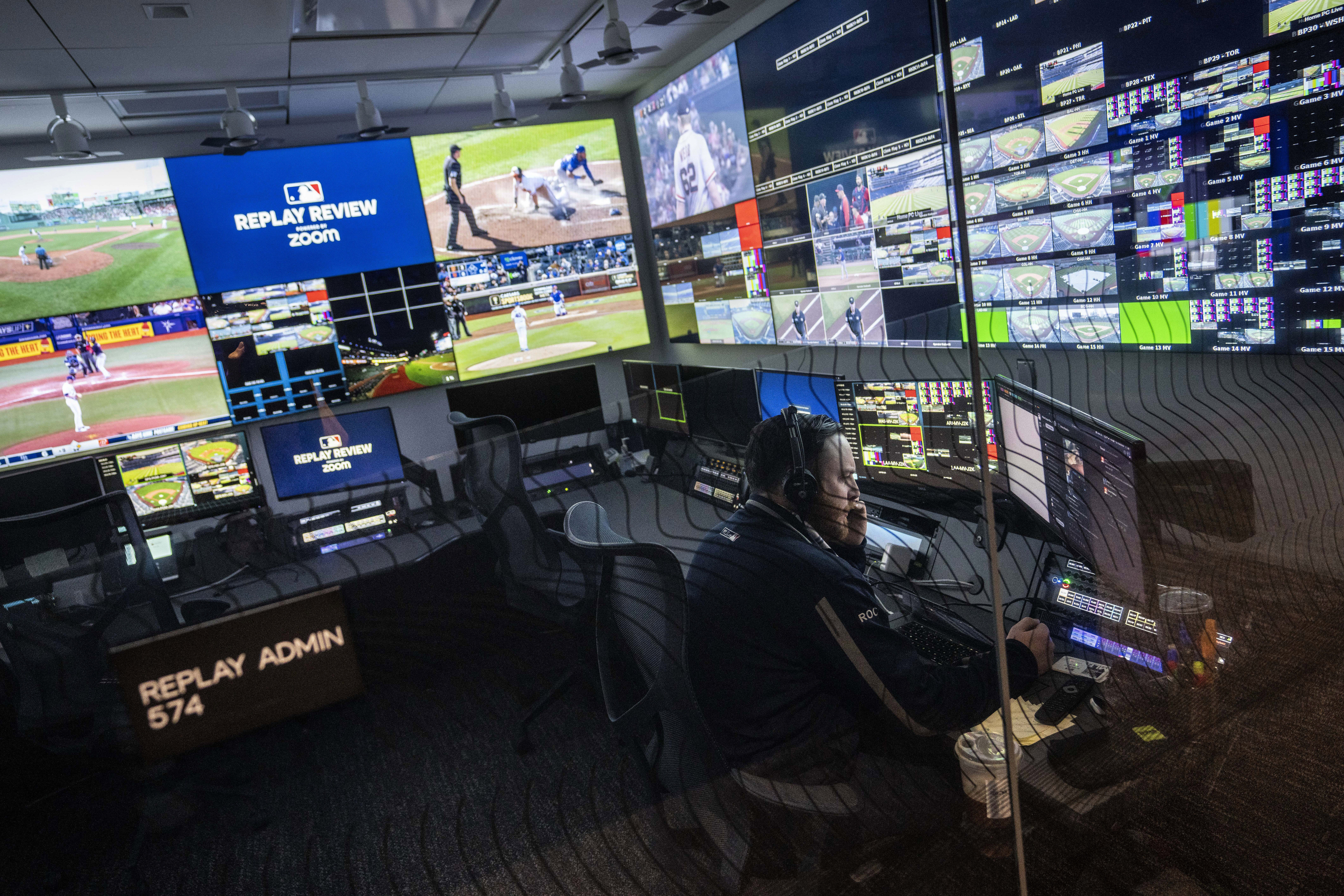 FILE - An employee works inside an administrative room at a Replay Review station during a tour at Major League Baseball headquarters in New York, March 28, 2023. Team-initiated video reviews were slightly less successful in the major leagues this year, dropping to 48.5% from 50.2% in 2022. 