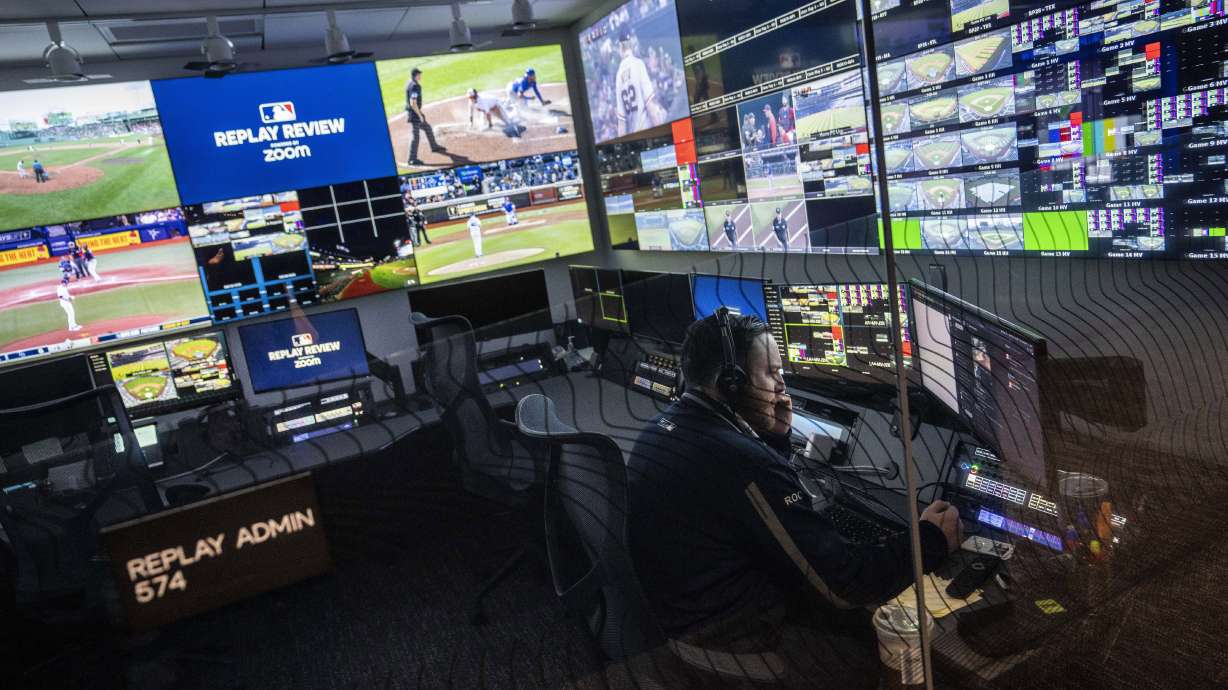 FILE - An employee works inside an administrative room at a Replay Review station during a tour at Major League Baseball headquarters in New York, March 28, 2023. Team-initiated video reviews were slightly less successful in the major leagues this year, dropping to 48.5% from 50.2% in 2022.