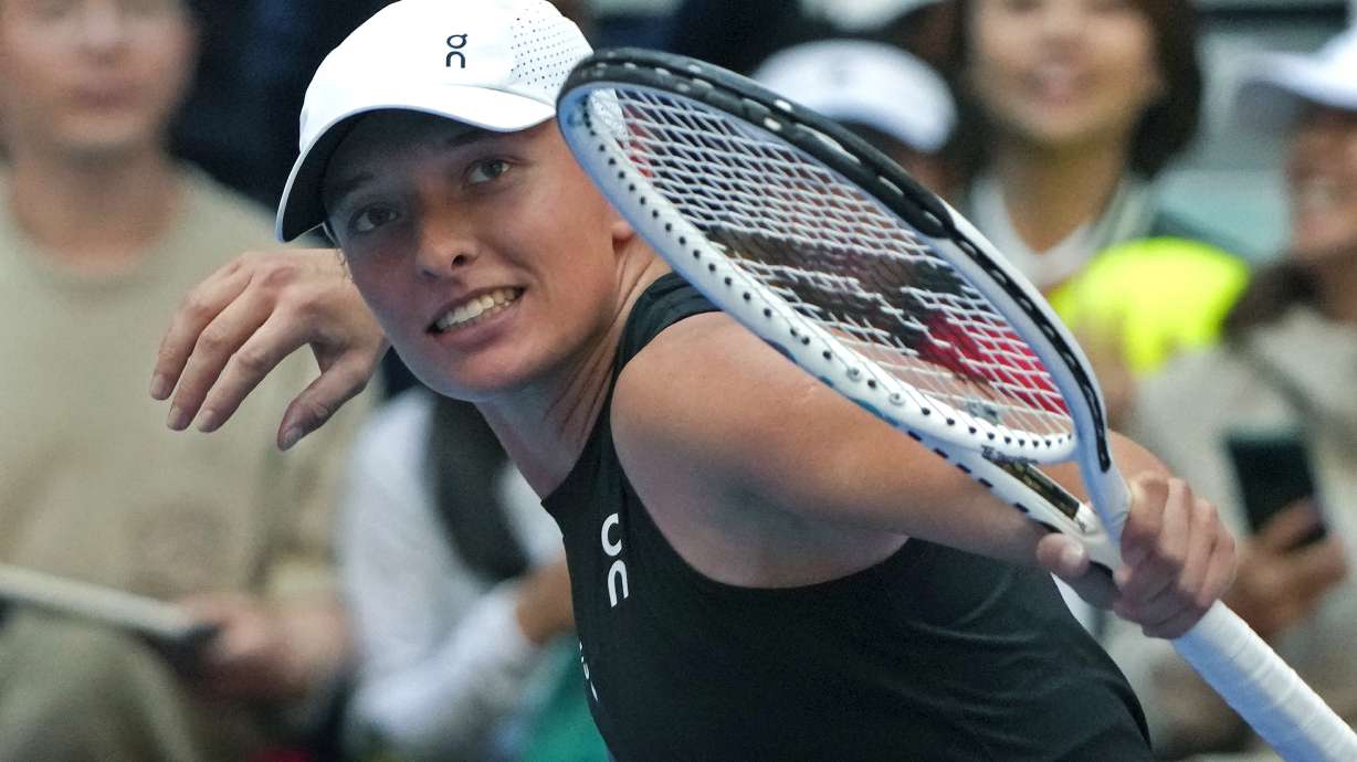 Iga Swiatek of Poland celebrates after defeating Coco Gauff of the United States in the women's singles semifinal match in the China Open tennis tournament at the Diamond Court in Beijing, Saturday, Oct. 7, 2023.