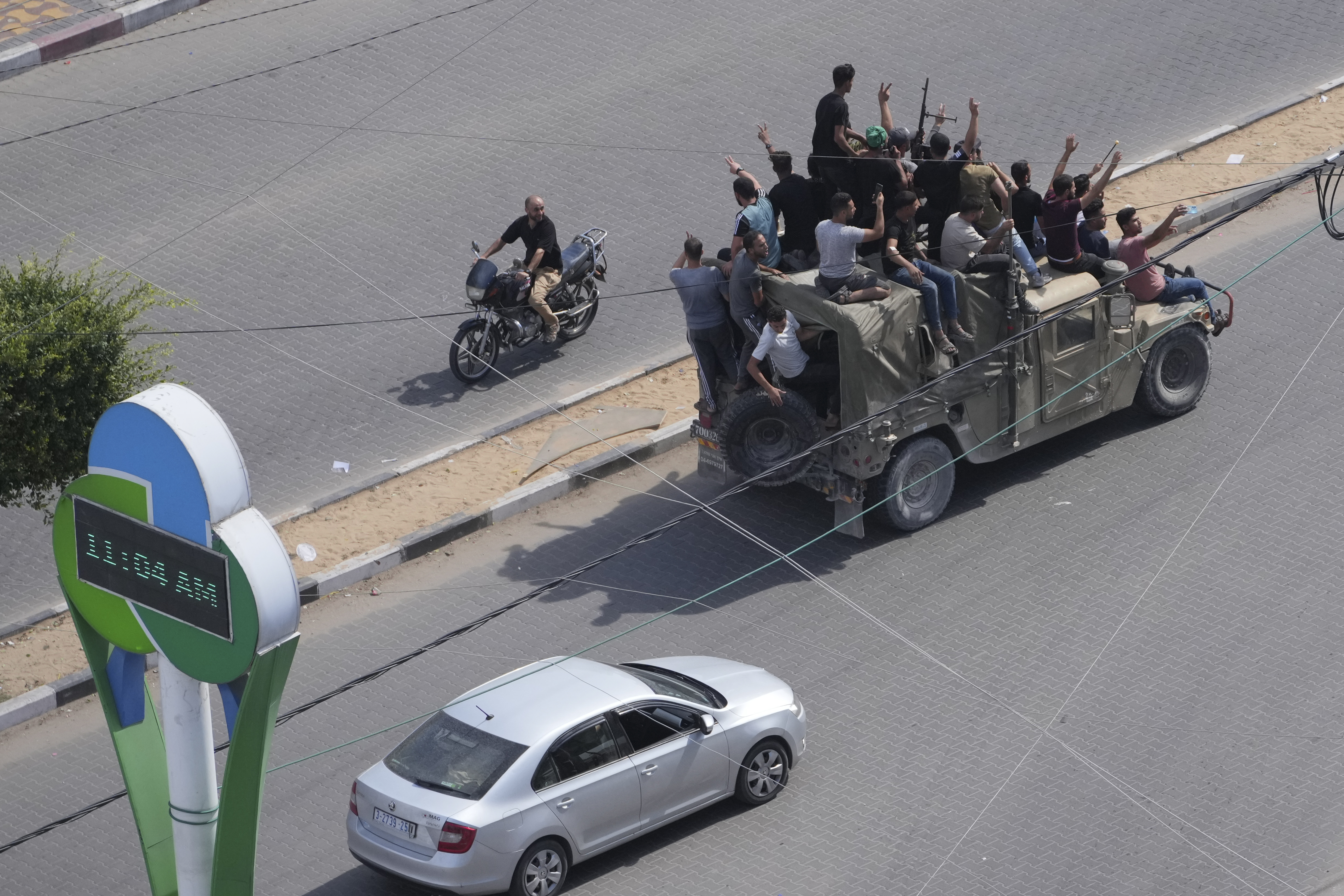 Palestinian militants drive a captured Israeli military vehicle in Gaza City on Saturday. The militant Hamas rulers of the Gaza Strip carried out an unprecedented, multi-front attack on Israel at daybreak Saturday, firing thousands of rockets as dozens of Hamas fighters infiltrated the heavily fortified border in several locations by air, land, and sea and catching the country off-guard on a major holiday.
