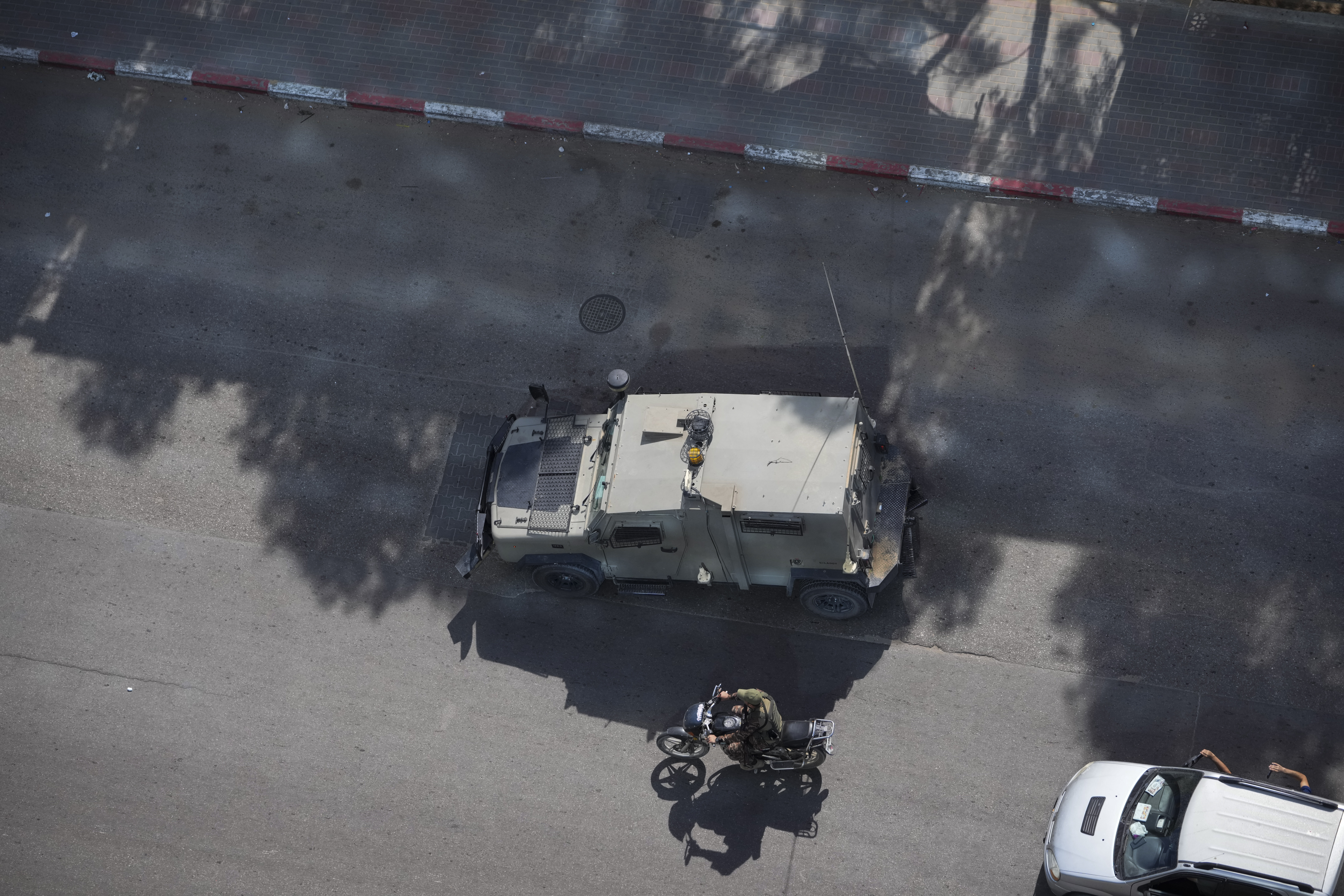Palestinian militants drive a captured Israeli military vehicle in Gaza City on Saturday. The militant Hamas rulers of the Gaza Strip carried out an unprecedented, multi-front attack on Israel at daybreak Saturday, firing thousands of rockets as dozens of Hamas fighters infiltrated the heavily fortified border in several locations by air, land, and sea and catching the country off-guard on a major holiday.