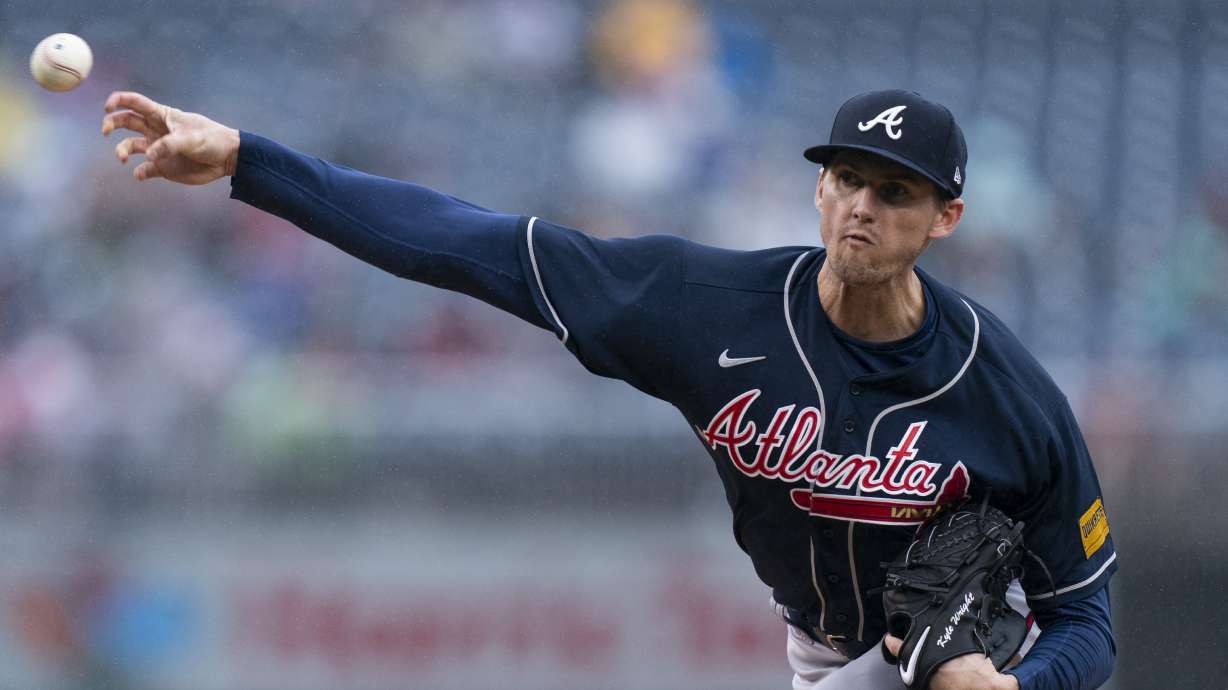 Atlanta Braves relief pitcher Kyle Wright delivers in the rain during the seventh inning of a baseball game against the Washington Nationals, Sunday, Sept. 24, 2023, in Washington.