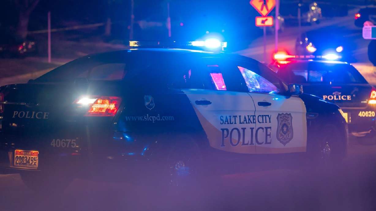 A Salt Lake City police car blocks traffic near 1100 E. 900 South following a deadly pursuit.