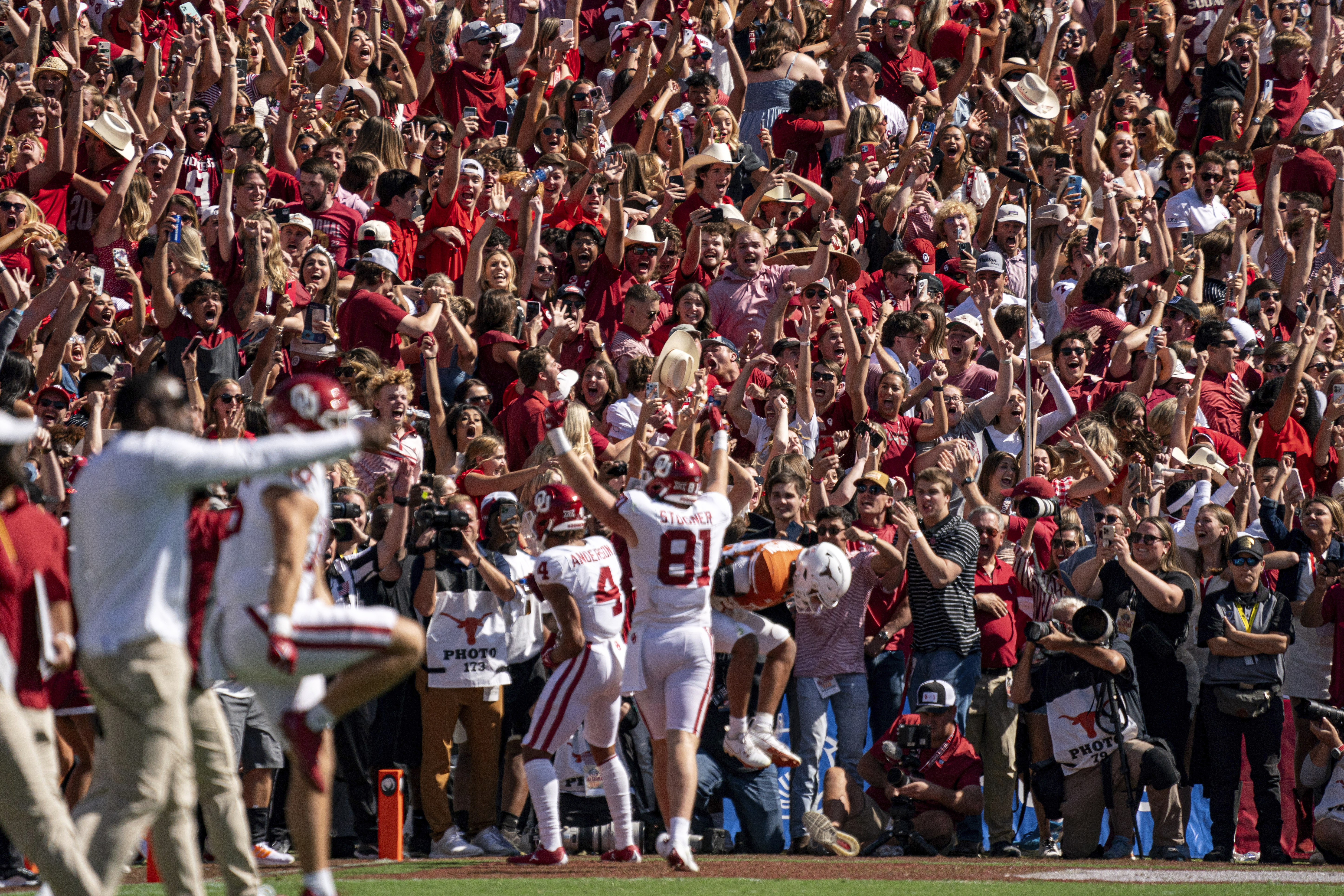 Oklahoma fans celebrate the game-winning touchdown reception by wide receiver Nic Anderson (4) during the second half of an NCAA college football game at the Cotton Bowl, Saturday, Oct. 7, 2023, in Dallas. Oklahoma won 34-30.