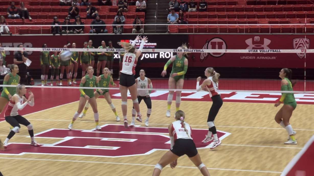 Utah's Allie Olsen goes up for a block against the Oregon ducks.