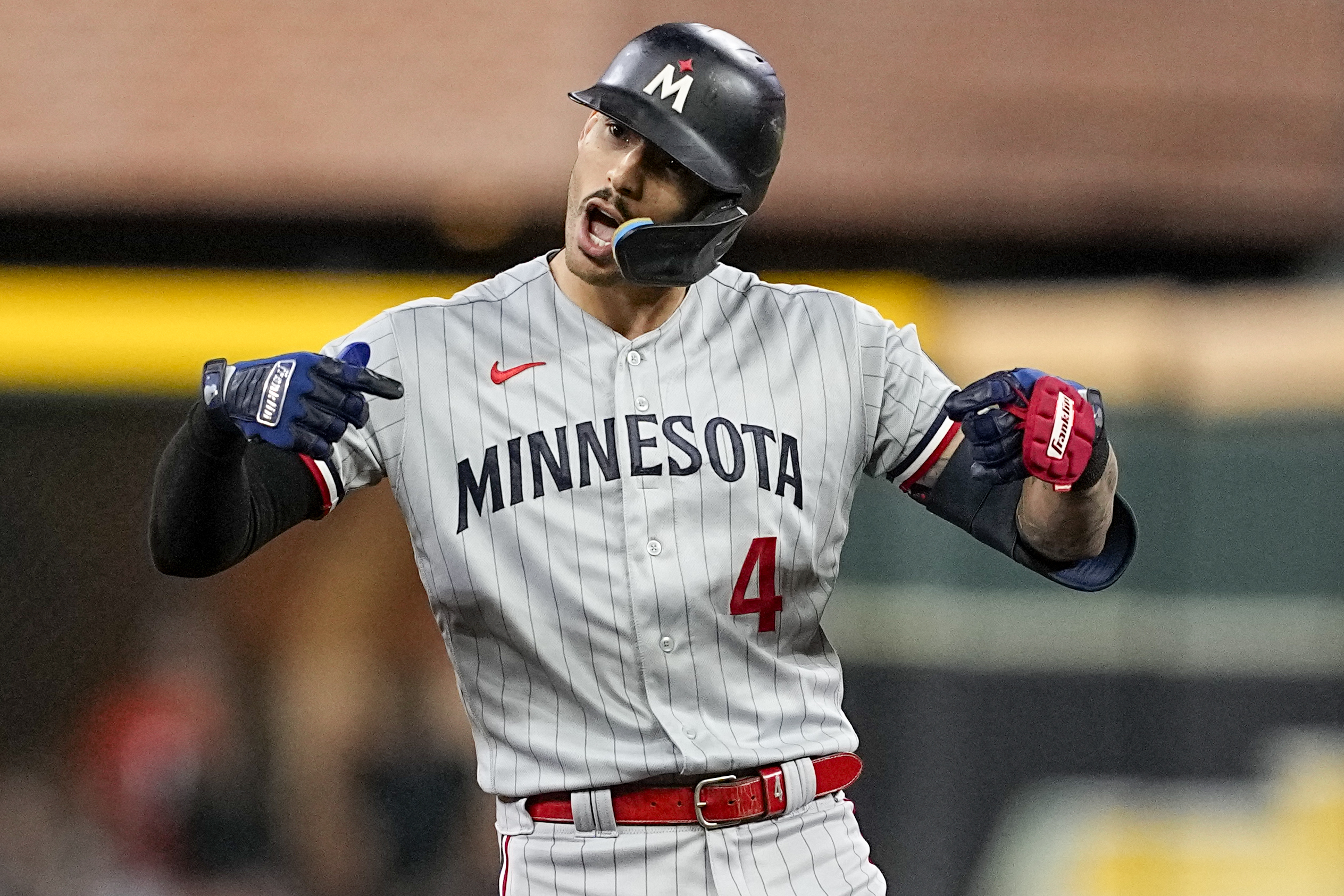 Minnesota Twins' Carlos Correa celebrates after a RBI-double against the Houston Astros during the first inning in Game 2 of an American League Division Series baseball game in Houston, Sunday, Oct. 8, 2023.