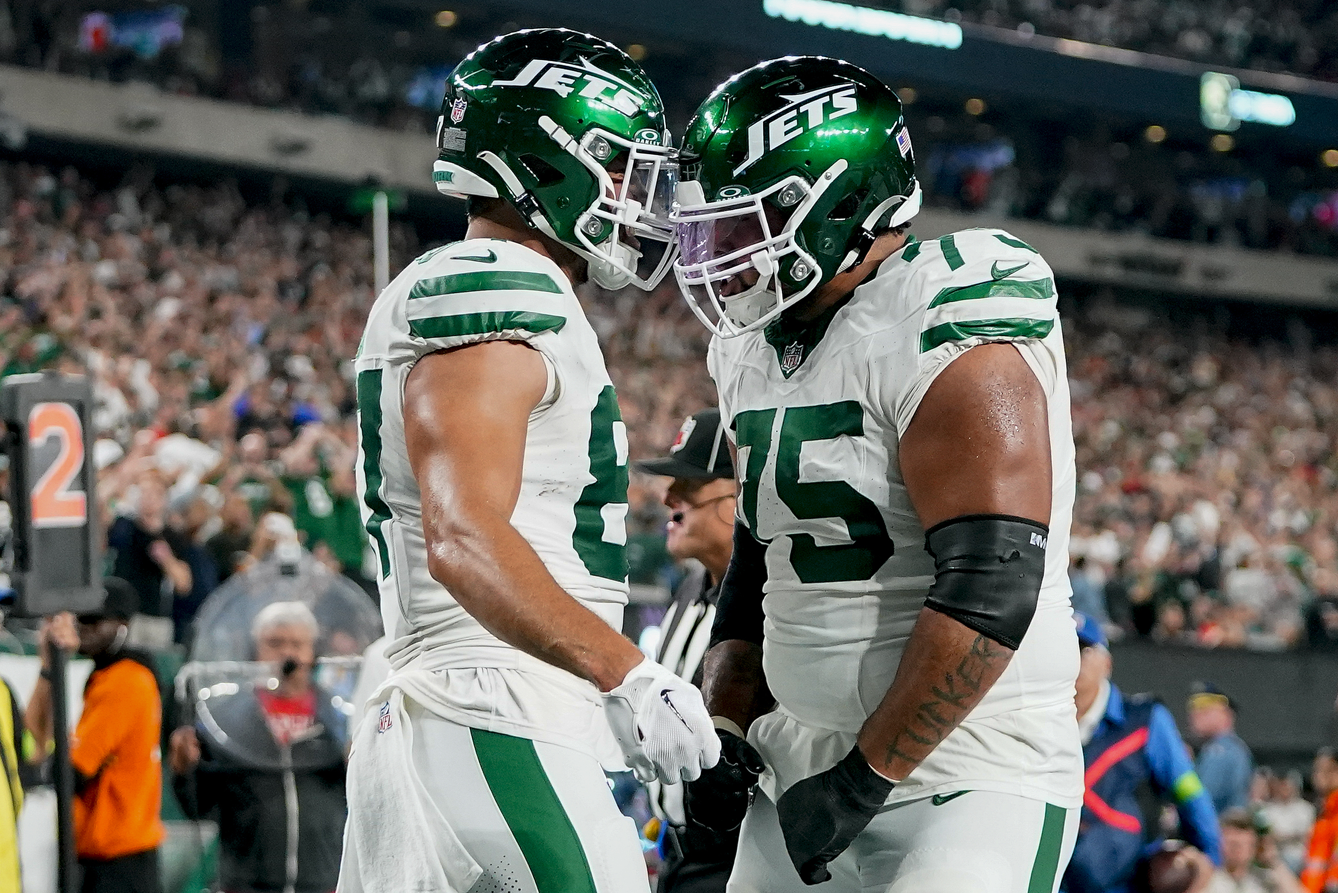 New York Jets tight end C.J. Uzomah (87) celebrates with guard Alijah Vera-Tucker (75) after scoring a touchdown against the Kansas City Chiefs during the second quarter of an NFL football game, Sunday, Oct. 1, 2023, in East Rutherford, N.J.