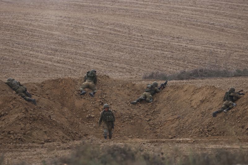 Israeli soldiers take position near the Israeli Gaza border, southern Israel, Monday. The militant Hamas rulers of the Gaza Strip carried out an unprecedented, multi-front attack on Israel at daybreak Saturday.