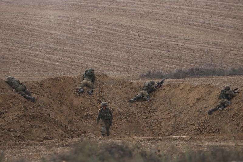 Israeli soldiers take position near the Israeli Gaza border, southern Israel, Monday. The militant Hamas rulers of the Gaza Strip carried out an unprecedented, multi-front attack on Israel at daybreak Saturday.